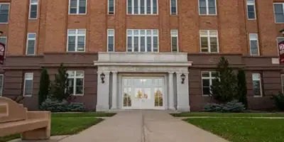 A close up of the doors of the old administration building on campus